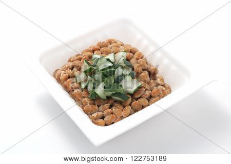 Natto, fermented soybeans with welsh onion on white background. (Japanese food)