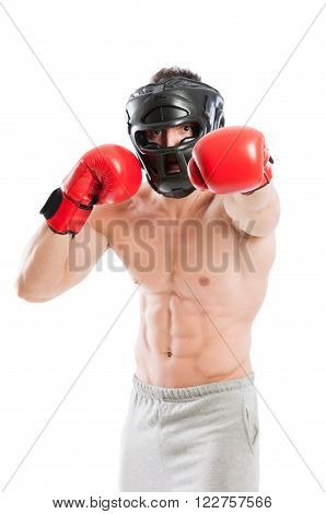 Boxer in fighting position wearing red boxing gloves and black protective helmet