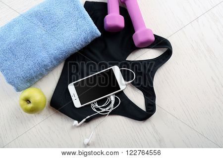 Sport clothes and equipment on wooden background