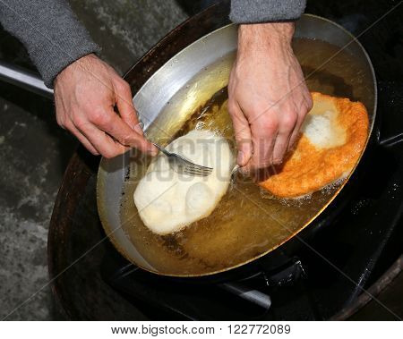 Fritters Dipped In Hot Oil In An Aluminum Pot