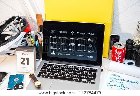 PARIS FRANCE - MARCH 21 2016: Apple Computers website on MacBook Pro Retina in a creative room environment showcasing Apple Event with Apple COO Jeff Williams and Care Kit presentation list of univeristies