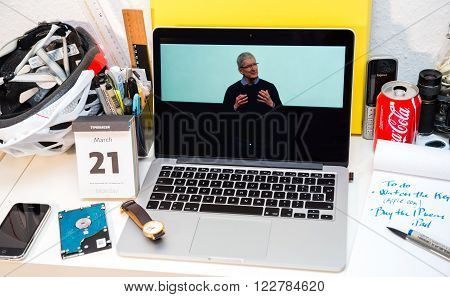 PARIS FRANCE - MARCH 21 2016: Apple Computers website on MacBook Pro Retina in a creative room environment showcasing Apple Event with Tim Cook explaining about iPhone gate
