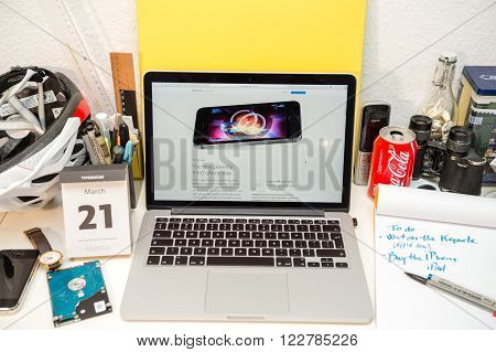 PARIS FRANCE - MARCH 21 2016: Apple Computers website on MacBook Pro Retina in a geek creative room environment showcasing the newly announced iPhone SE and its Chip