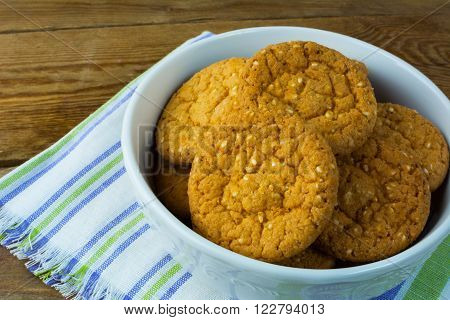 Sesame cookies on rustic wooden background close up. Breakfast cookie. Dessert cookies. Cookies. Breakfast. Sweet cookie. Homemade cookies.