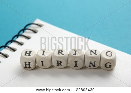 HIRING word written on wood block. Wooden Abc.