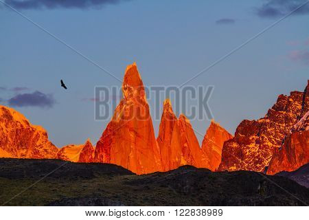 Fantastic Patagonia. The crimson sunset illuminates the top of impressive cliffs Fitz Roy