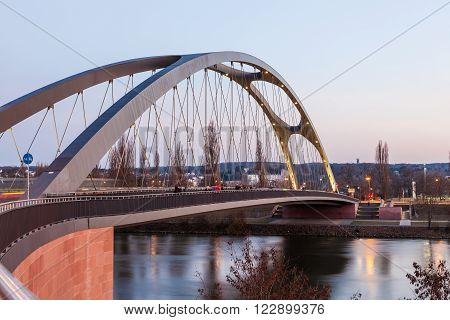 FRANKFURT GERMANY - MAR 14: Osthafen bridge over the Main river illuminated at dusk. March 14 2016 in Frankfurt Main Germany