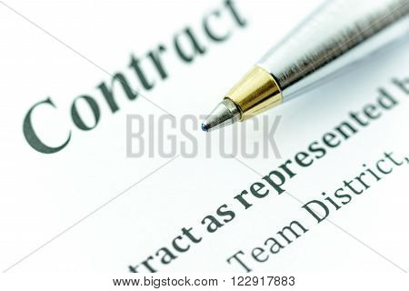 Blue ballpoint pen on a contract, ready to sign and fill a form.