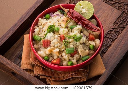 Rava Upma - Popular south Indian breakfast wiih semolina and vegetables, selective focus, Upma or upama is a South Indian breakfast, cooked from dry roasted semolina. seasonings of vegetables