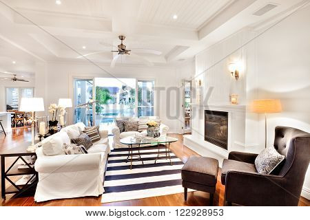 Beautiful sofa set with a glass table in the center and a telescope at the window in a luxury house