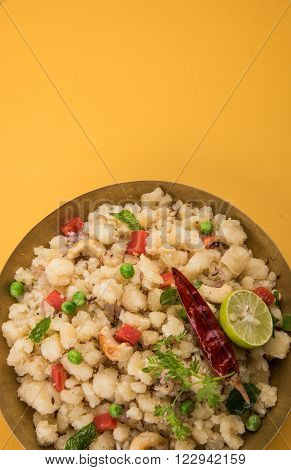 Rava Upma - Popular south Indian breakfast wiih semolina and vegetables, selective focus, Upma or upama is a South Indian breakfast, cooked from dry roasted semolina. seasonings of vegetables
