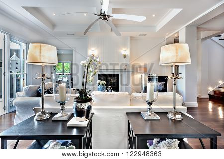 Beautiful drawing room with sofa set and two wooden table  and fan which is switched off.