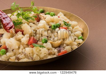 Rava Upma - Popular south Indian breakfast wiih semolina and vegetables, selective focus, Upma or upama is a South Indian breakfast, cooked from dry roasted semolina. seasonings of vegetables