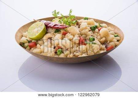 Rava Upma - Popular south Indian breakfast wiih semolina and vegetables, selective focus, Upma or upama is a South Indian breakfast, cooked from dry roasted semolina. seasonings of vegetables