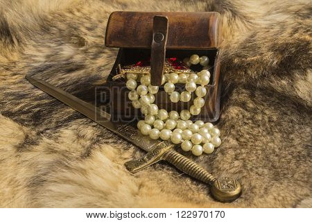 a casket and dagger with jewels on natural fur a wild Wolf
dagger and casket
