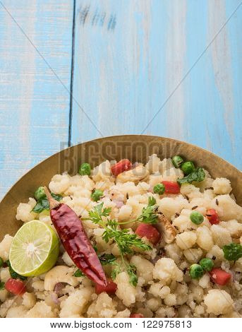 Rava Upma - Popular south Indian breakfast wiih semolina and vegetables, selective focus, Upma or upama is a South Indian breakfast, cooked from dry roasted semolina. seasonings of vegetables