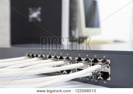 Lan network switch with ethernet cables plugged in on computer background
** Note: Shallow depth of field