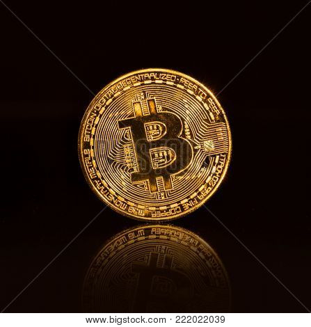 Bitcoin gold coins on black background. Virtual cryptocurrency concept.
