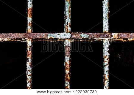 Old cracked iron metal rusty window bar as prison and freedom concept or jale time breakdown vintage background