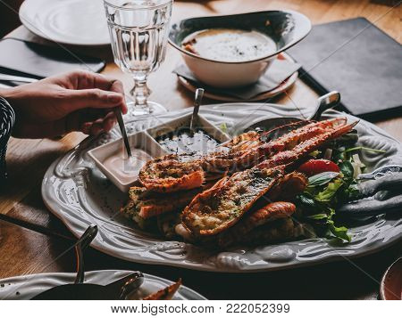 Dish with langoustine on salad with sauces in restaurant in Hofn, Iceland