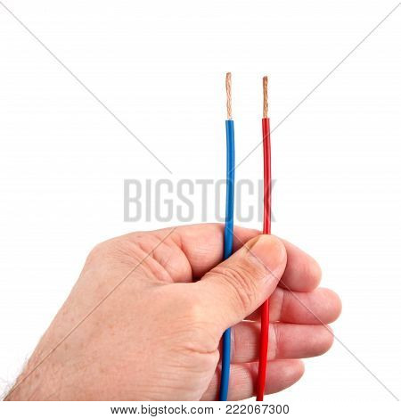 Two parallel wires red and blue in one hand isolated on white