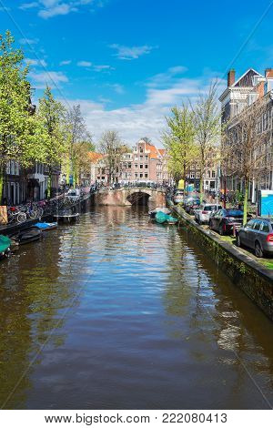 Facades of dutch houses and bridge over canal, Amstardam scenery, Netherlands