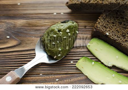 sandwiches with avocado paste on wooden table