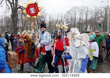 Kharkiv, Ukraine - January 13, 2018 - Participants traditional Christmas of Verteps Parade (nativity Scene), Christmas stars, carols singing. People wearing carnival clothes posing and smiling. Winter outdoor image.