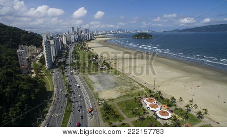 Beautiful beach in South America, Brazil, paragliding flying in the sky