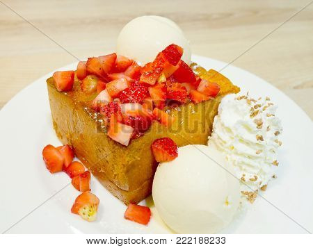 Honey toast or brick toast with fresh strawberry, vanilla ice-cream and whipped cream