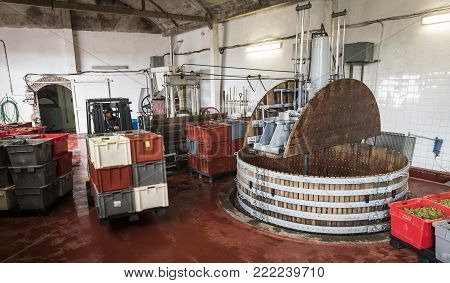 Dizy, France - September 10, 2017:  Old wooden wine presses (pressoir) and man working with forklift at Champagne House Regent in Dizy, France