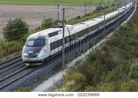 Reims, France - September 12, 2017: the high speed train of France, the TGV of the SNCF, at great speed in the evening.