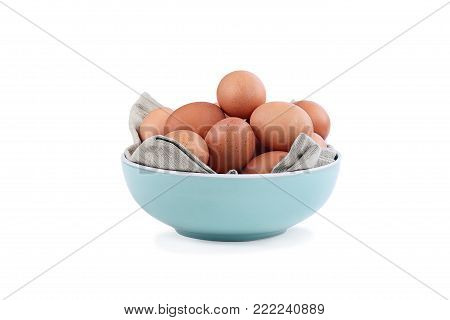 Isolated farm fresh organic brown chicken eggs from free range chickens in a blue bowl over a white background with light shadow. Clipping path included.