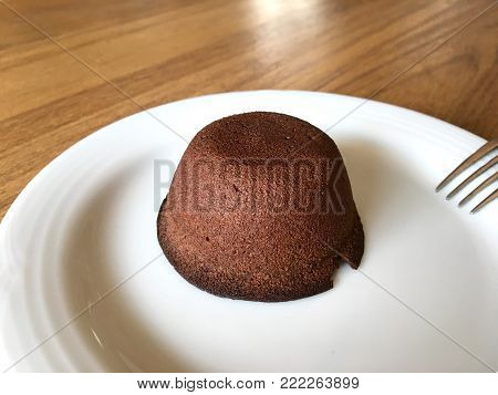 Petit Gateau. Baked chocolate dessert on white dish.