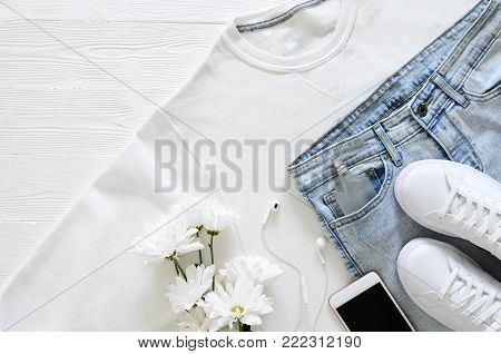 Womens fashion white clothing, shoes, accessories (white leather sneakers, sweatshirt, headphones, perfume. Fashion concept. View from above, Flat lay. Spring summer collection