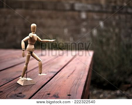 Wooden Drawing Mannequin Figure Running on Ledge