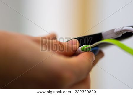 Two Mobile Phones Charging Pluged Into The Charger