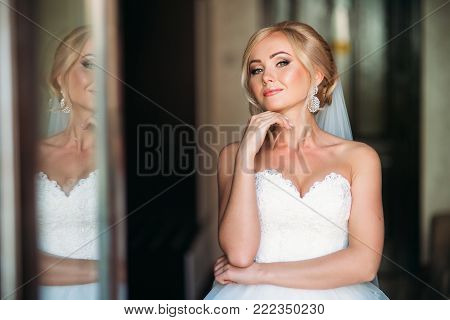 Beautiful bride in weddind dress posing to photographer. sunny day