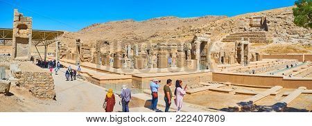 PERSEPOLIS, IRAN - OCTOBER 13, 2017: Panorama of Persepolis archaeological site from the hill with a view on Hundred Columns Hall and Rahmet Mount behind it, on October 13 in Persepolis.