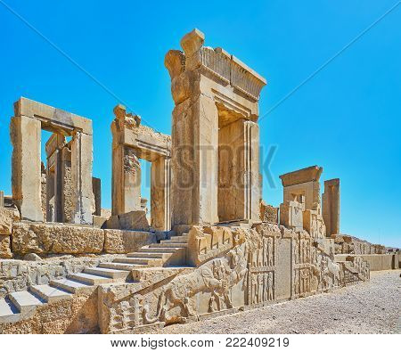 The ancient ruins of Tachara palace in Persepolis archaeological site with preserved reliefs and carved decors, Iran.
