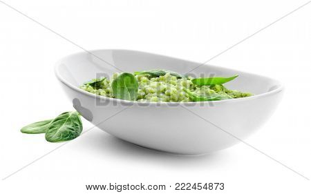 Dish with tasty spinach risotto on white background