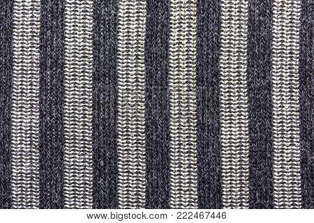 Wool fabric with vertical stripes of black and bright colors, background, texture