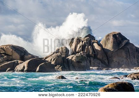 Impressive waves crashing on rocks coastline at San vicente de Grove, Galicia, Spain. Sunny day