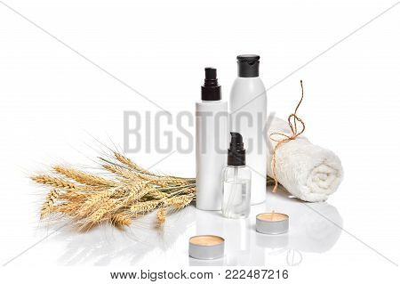 Herbal and mineral skincare. Jar of cream, oil with wheat, white cosmetic bottles. Without label. The concept for advertising cosmetics. Still life. Copy space
