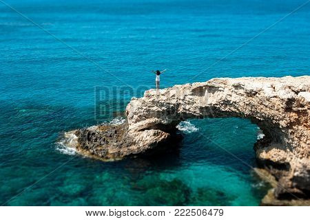 The girl is happy on the rock by the sea. A man on the edge of a cliff by the sea. Tourist at the resort. The traveler looks at the sea. The rest of Europe by the sea. Beautiful seascapes