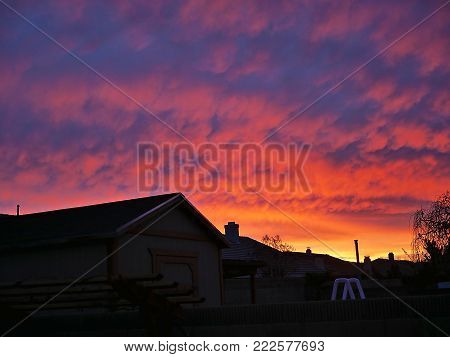 Colorful Purple and Orange Sunset over Neighborhood Houses