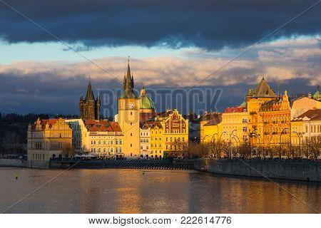 Beautifull night view of the Charles Bridge, the Old Town Bridge Tower, and the Old Water Tower, the Smetana Embankment and the Prague Beer Museum in Czech Republic New Year's Eve.