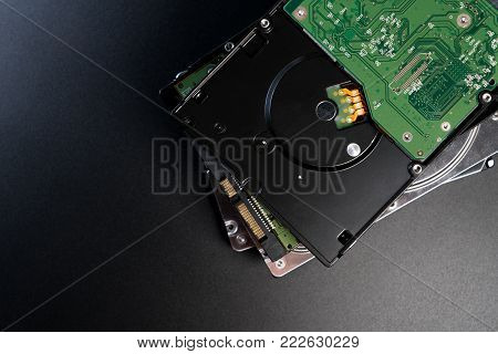 Close up of internal hard disk drive or hdd of personal computer on black background. Stack of hard disk drive pc with copy space for text.