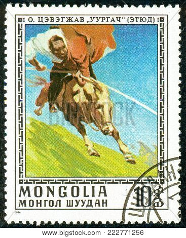 Ukraine - circa 2018: A postage stamp printed in Mongolia show Taming wild horse. Series: Paintings by O. Cevegshava. Circa 1976.