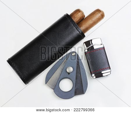 Black leather pouch with two Cuban cigars, cutter and lighter, isolated on white background